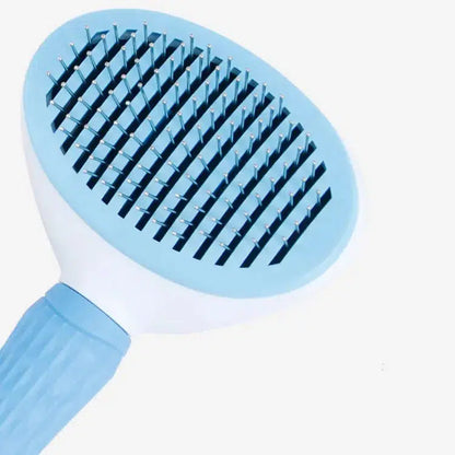 Brosse bleue avec poussoir pour chien et chat